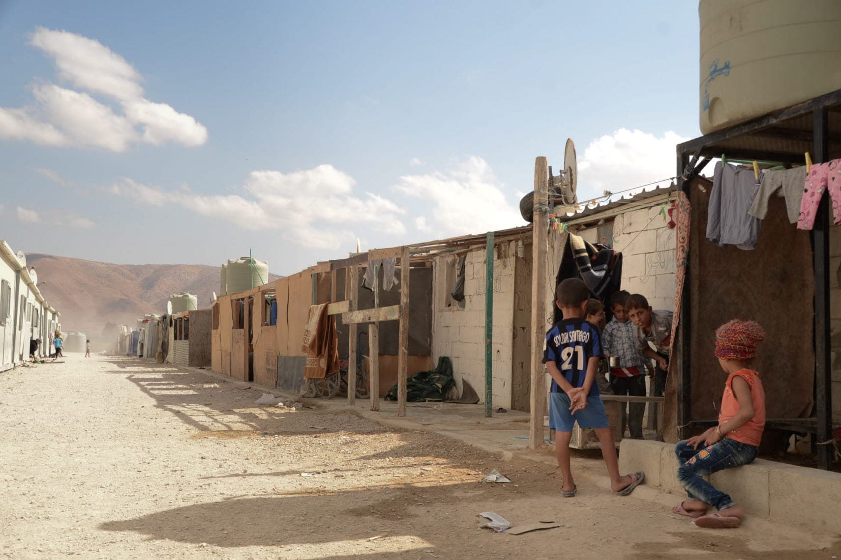 A street with barracks of a camp for displaced people. A street with barracks of a camp for displaced people.