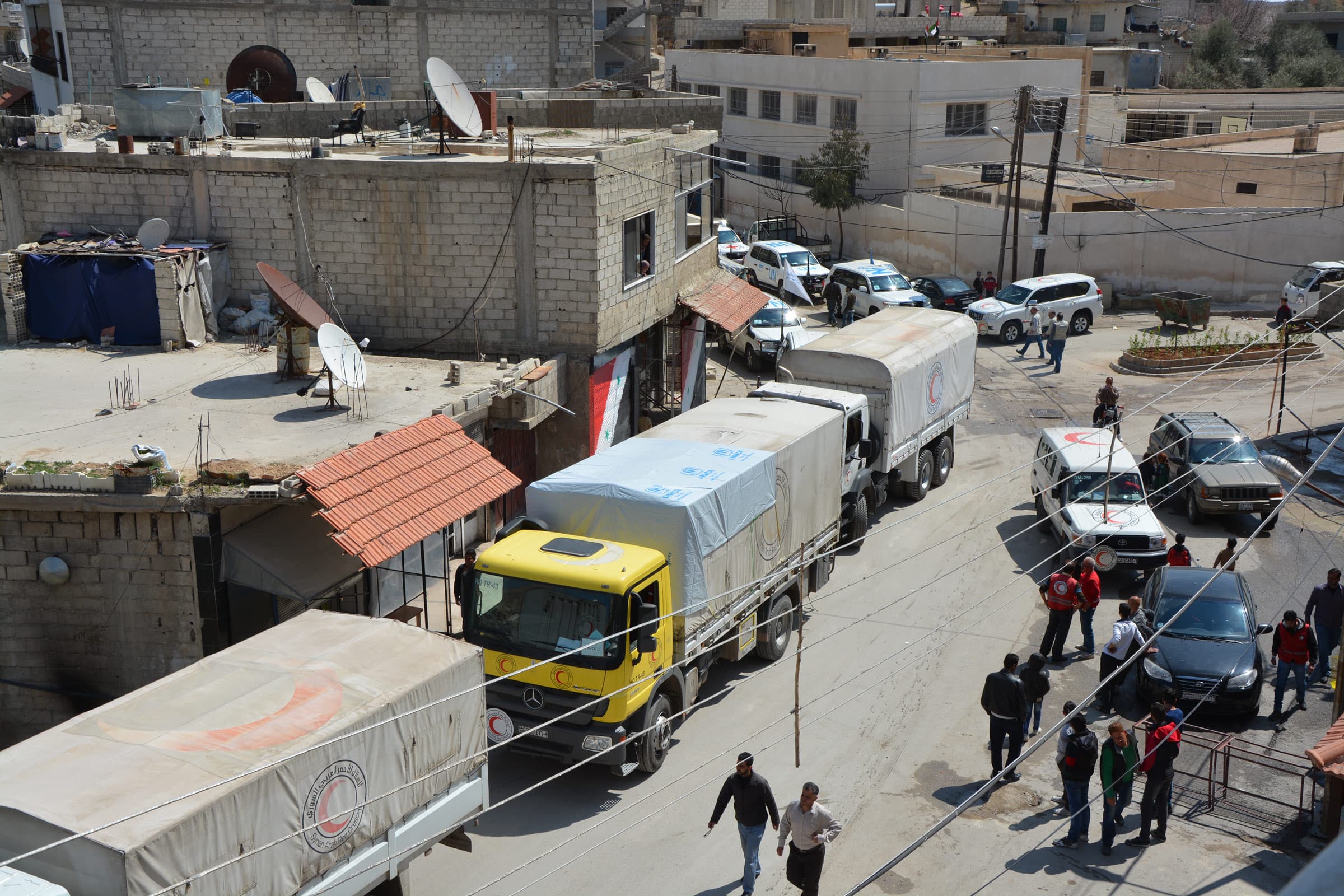 A convoy of trucks in a Syrian town. A convoy of trucks in a Syrian town.